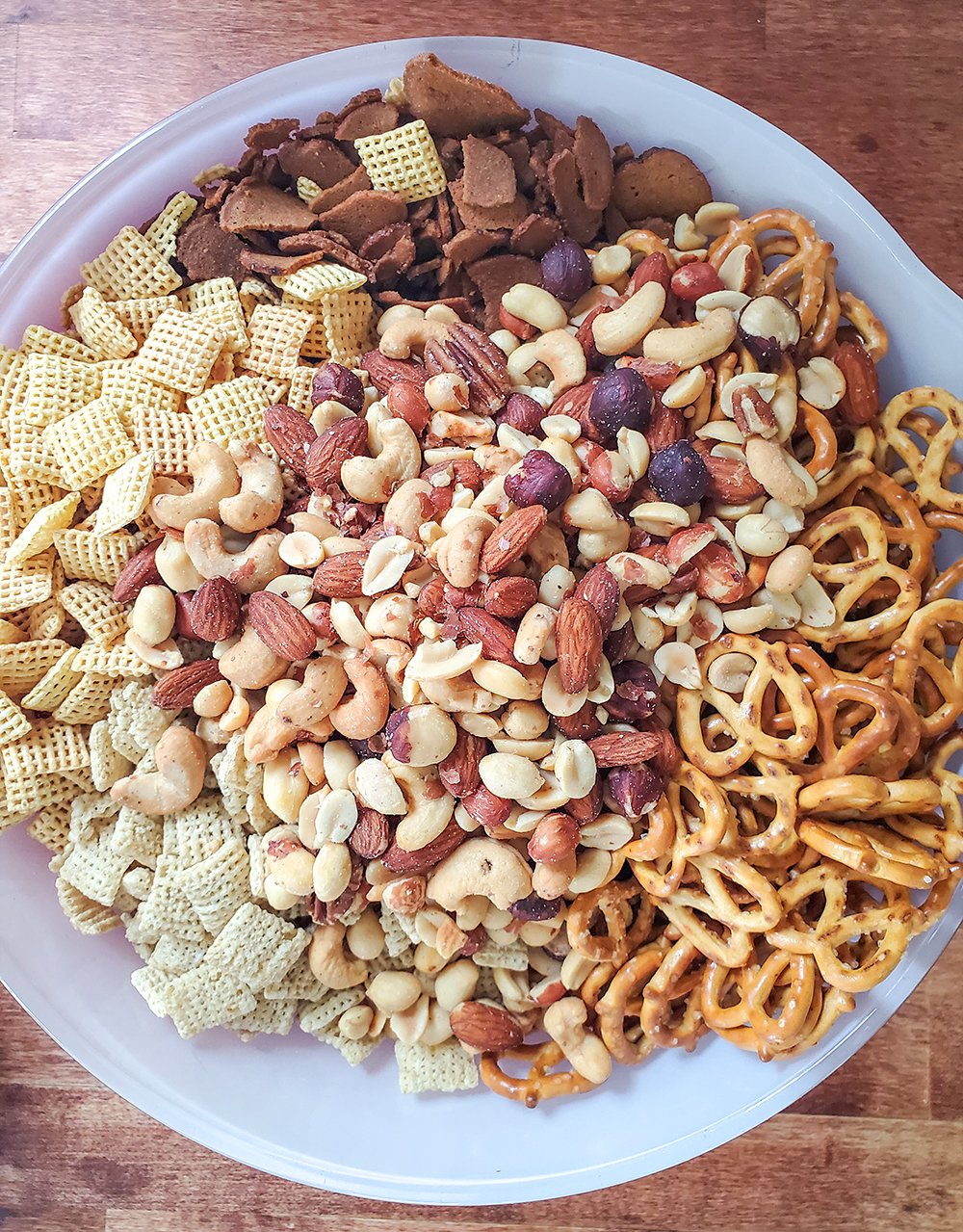 Chex mix ingredients ready to be baked.