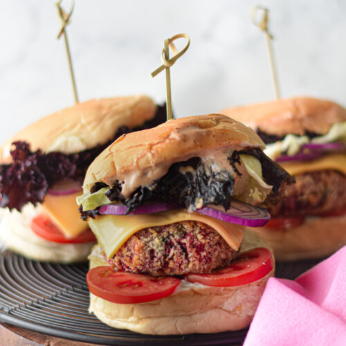 a plate of veggie burgers with toppings on them