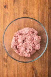 a bowl of ground meat for swedish meatballs