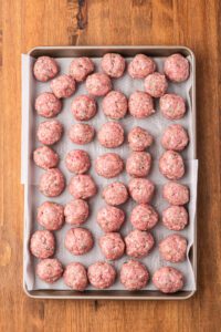 meatbalss ready to be cooked - on a cookie sheet
