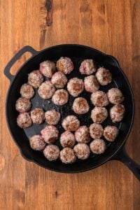 browned meatballs in a cast iron skillet