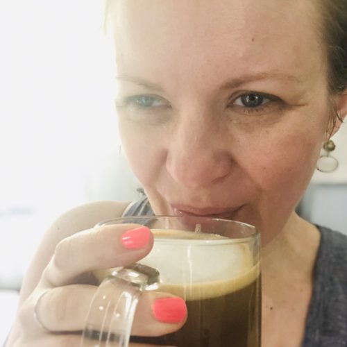 Janel from NellieBellie holding a mug of coffee