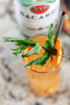 Bacardi rum in an orange sunset cocktail with fresh mint