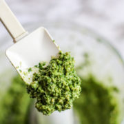 a spatula of fresh basil pesto