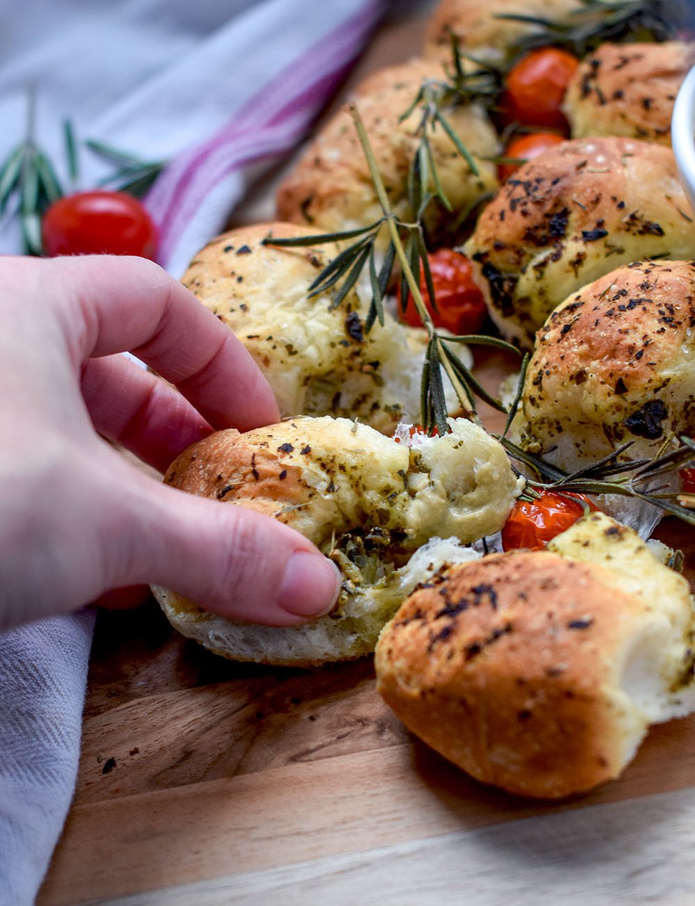 Bread being pulled from Christmas Bread Sharing Wreath