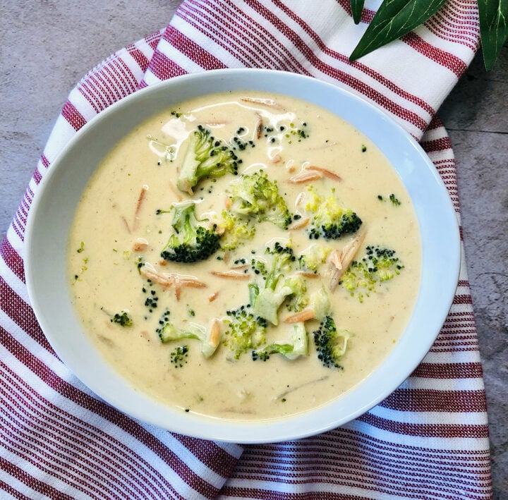 Broccoli cheese soup with carrots in a bowl.