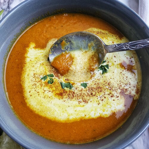 carrot and ginger soup with yogurt on top.