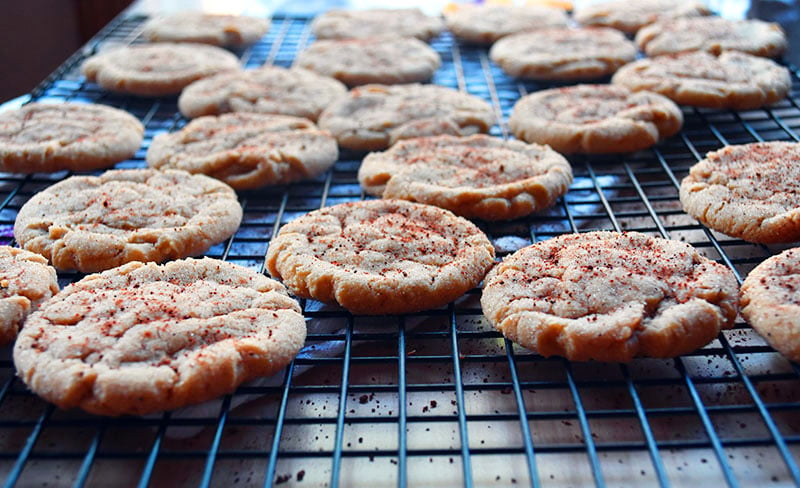 a big batch of ginger cookies on a cooling rack