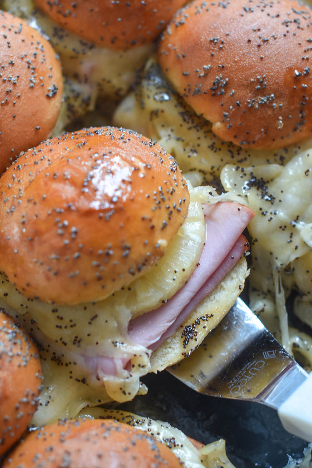 A Ham and Cheese Slider with pineapple and poppyseeds