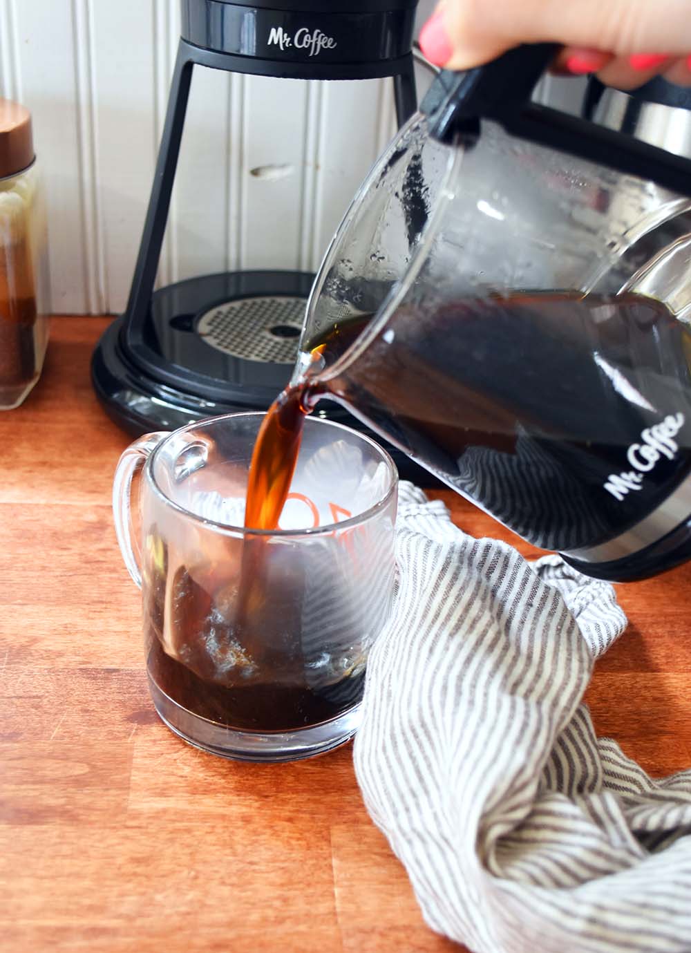Pouring up a cup of hot coffee from the Mr.Coffee machine