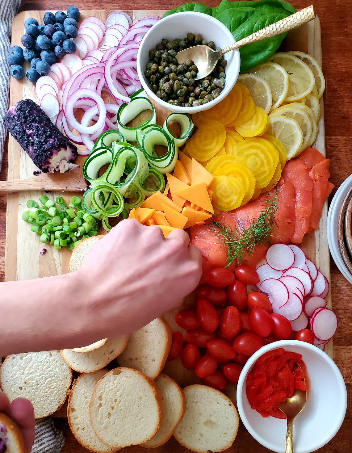 Salmon lox and toppings on a bruch charcuterie board