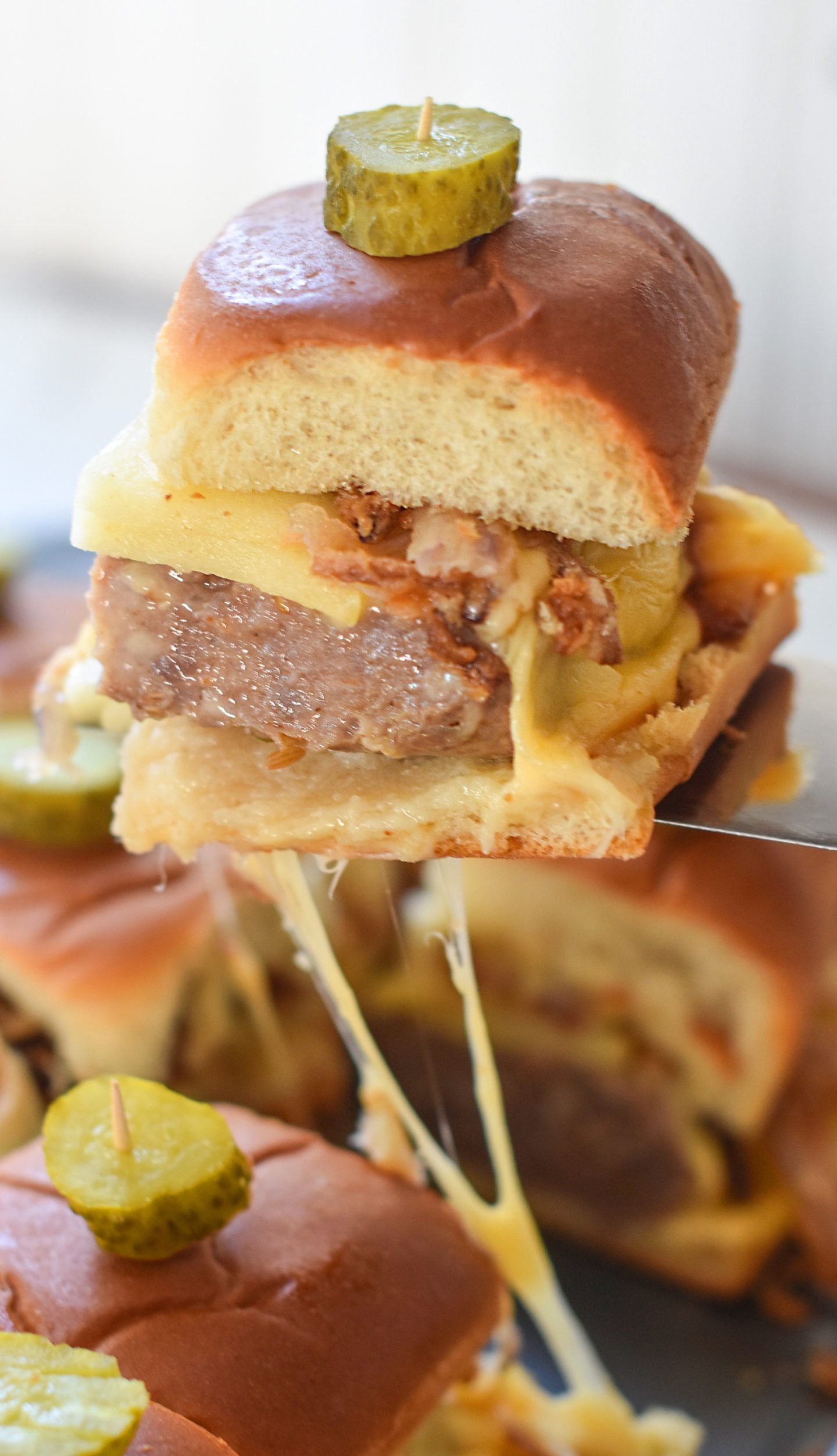 Italian sausage, cheese, fried onions, and apple sliders.